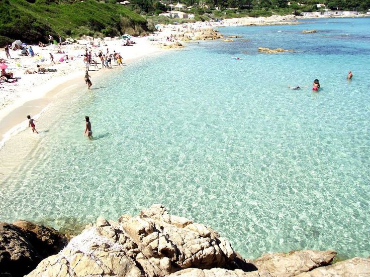 Corsica Yacht Charter: Complete Guide to the Isle of Beauty Yacht anchored in a turquoise cove near dramatic coastal cliffs, similar to Corsica's rugged beauty