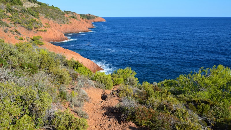 Discover the French Riviera by Sea: A Nautical Guide to Coastal Gems Stunning red-rock coastline of the Esterel seen from a yacht on the French Riviera