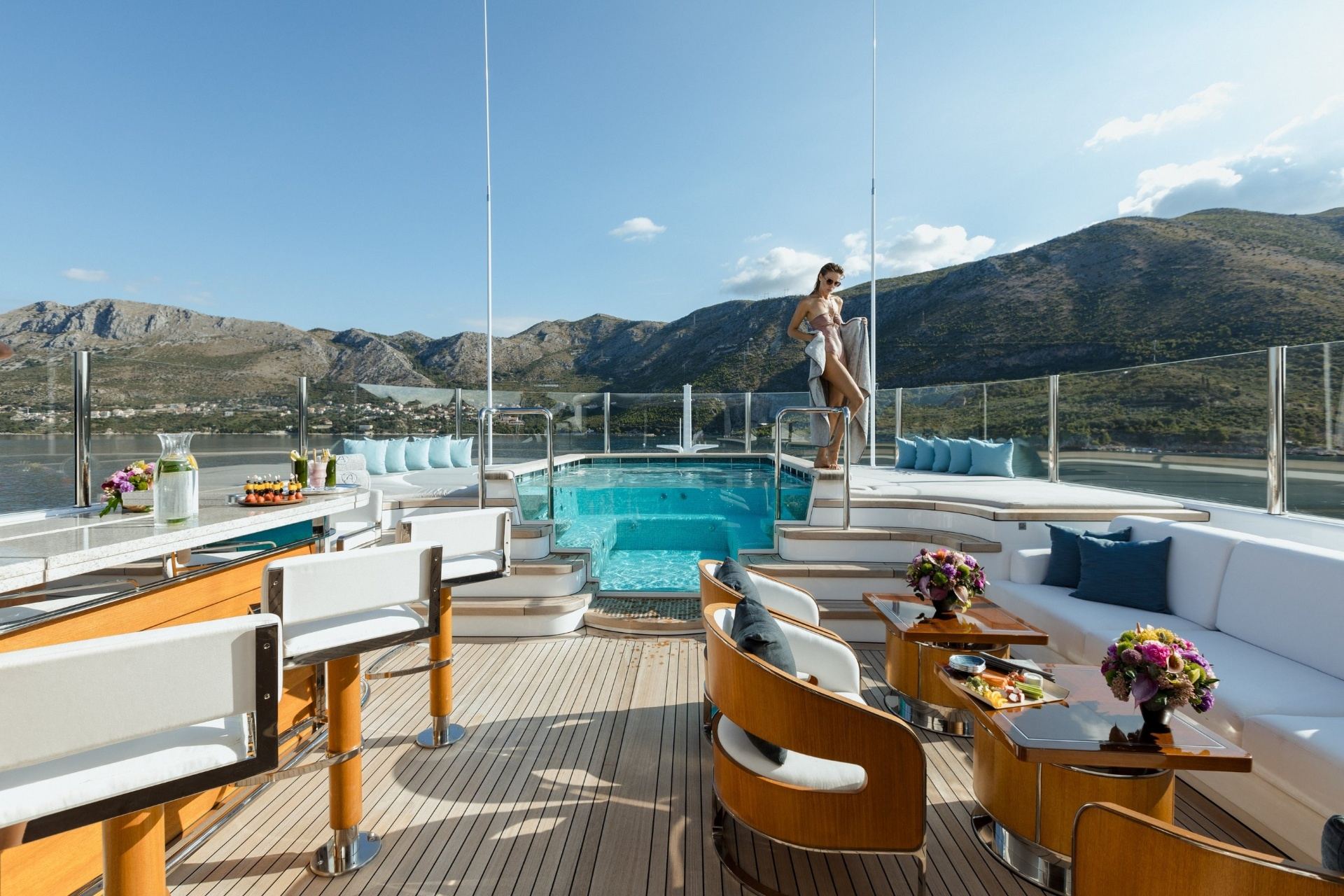 Sardinia Yacht Charter Itinerary: 7-Day Cruise from the French Riviera Superyacht pool deck overlooking Sardinia's emerald waters at Costa Smeralda