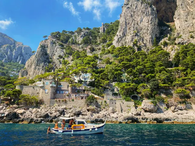 Marina Piccola: Capri cliffs above a rocky cove with a boat