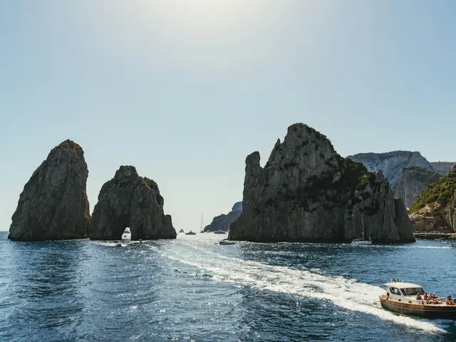 Faraglioni Rocks: The Faraglioni sea stacks of Capri seen from a boat