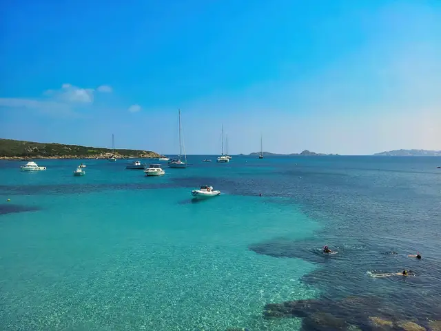 Spiaggia del Principe: Boats floating in clear turquoise Sardinian water