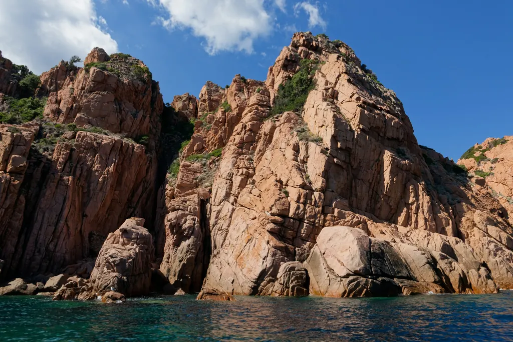 Day 2: Red granite cliffs rising from the sea on the west coast of Corsica