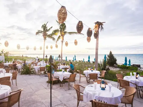 Mood photo (not the venue): Seafront dining terrace with lanterns