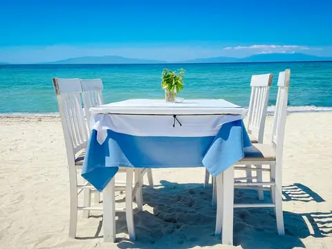Mood photo (not the venue): Table for two on the sand by the sea