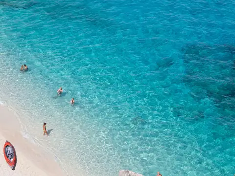 Mood photo (not the venue): Clear turquoise water off a sandy beach