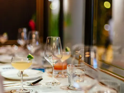 Mood photo (not the venue): Stemmed glasses on a set table