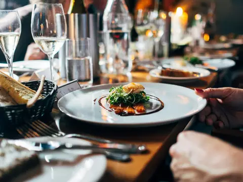 Mood photo (not the venue): Fine dining plate at a candlelit table