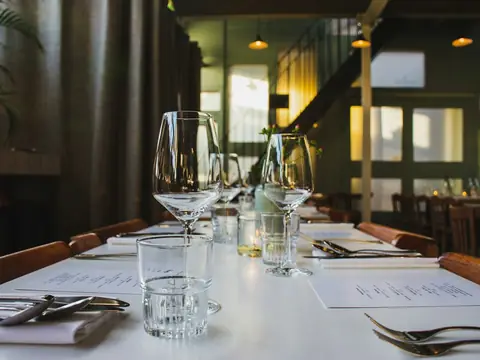 Mood photo (not the venue): Crystal glasses on a dining table